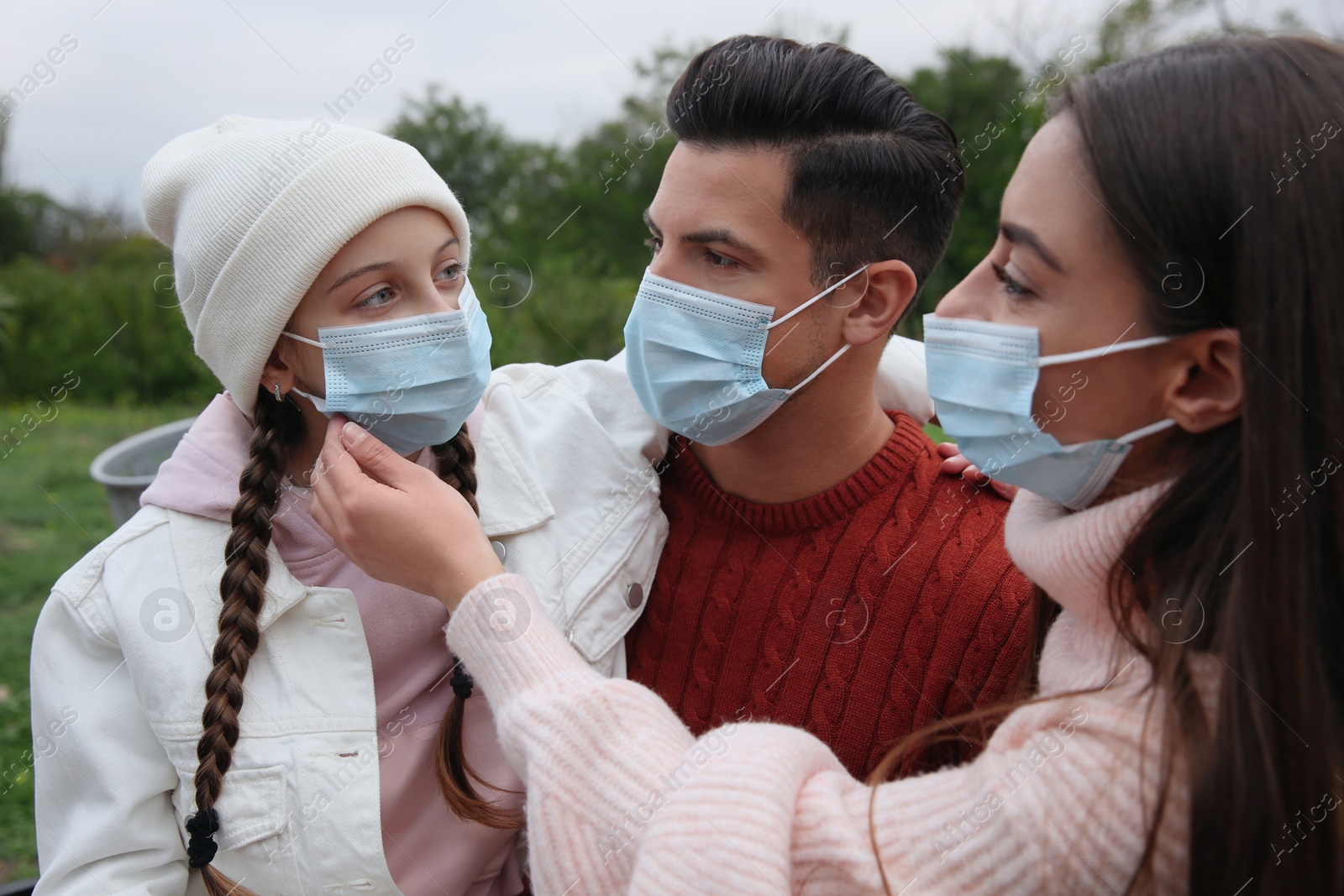 Photo of Lovely family spending time together in park during coronavirus pandemic