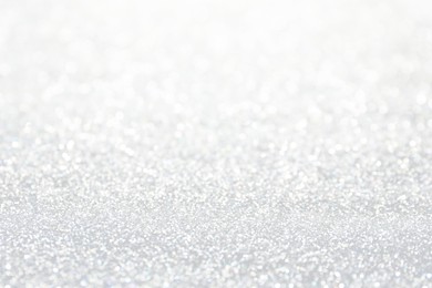 Shiny white glitter as background, closeup view