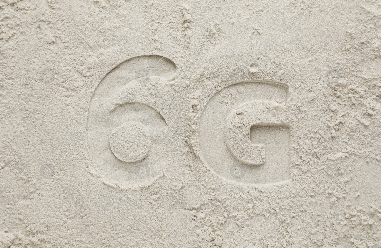 Photo of 6G technology, Internet concept. Print of number and letter on white sand, flat lay