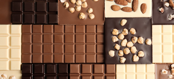 Image of Many different delicious chocolate bars as background,top view. Banner design 