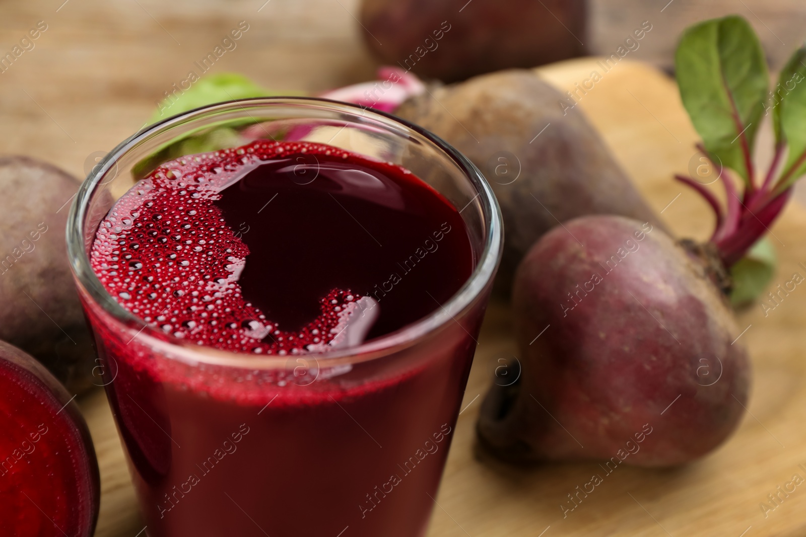 Photo of Freshly made beet juice on table, closeup