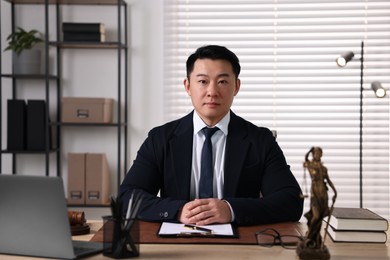 Photo of Notary working at wooden table in office