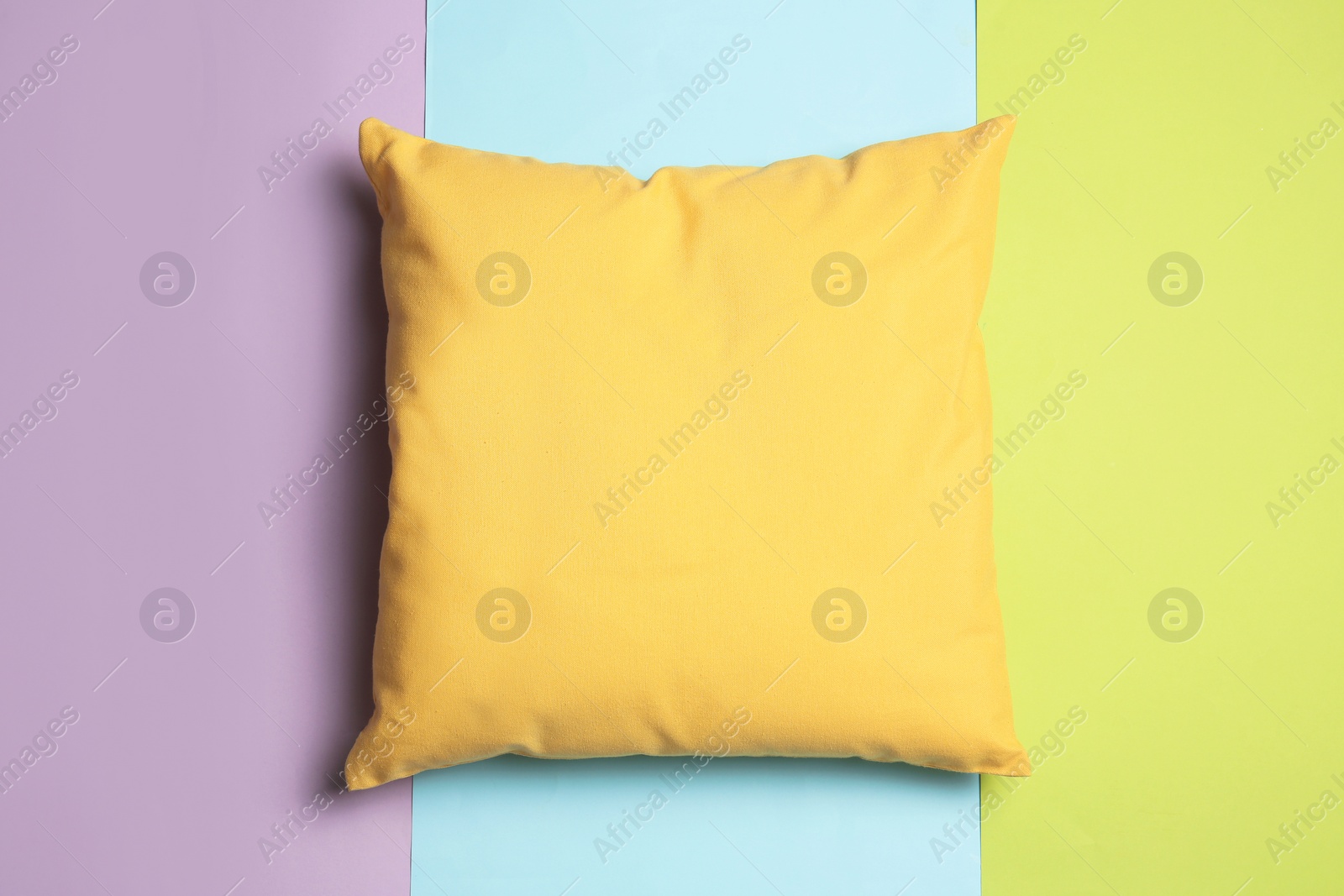 Photo of Soft decorative pillow on color background, top view