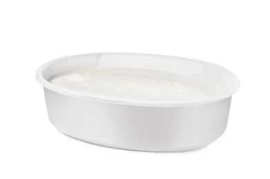 Plastic container of tasty cream cheese isolated on white