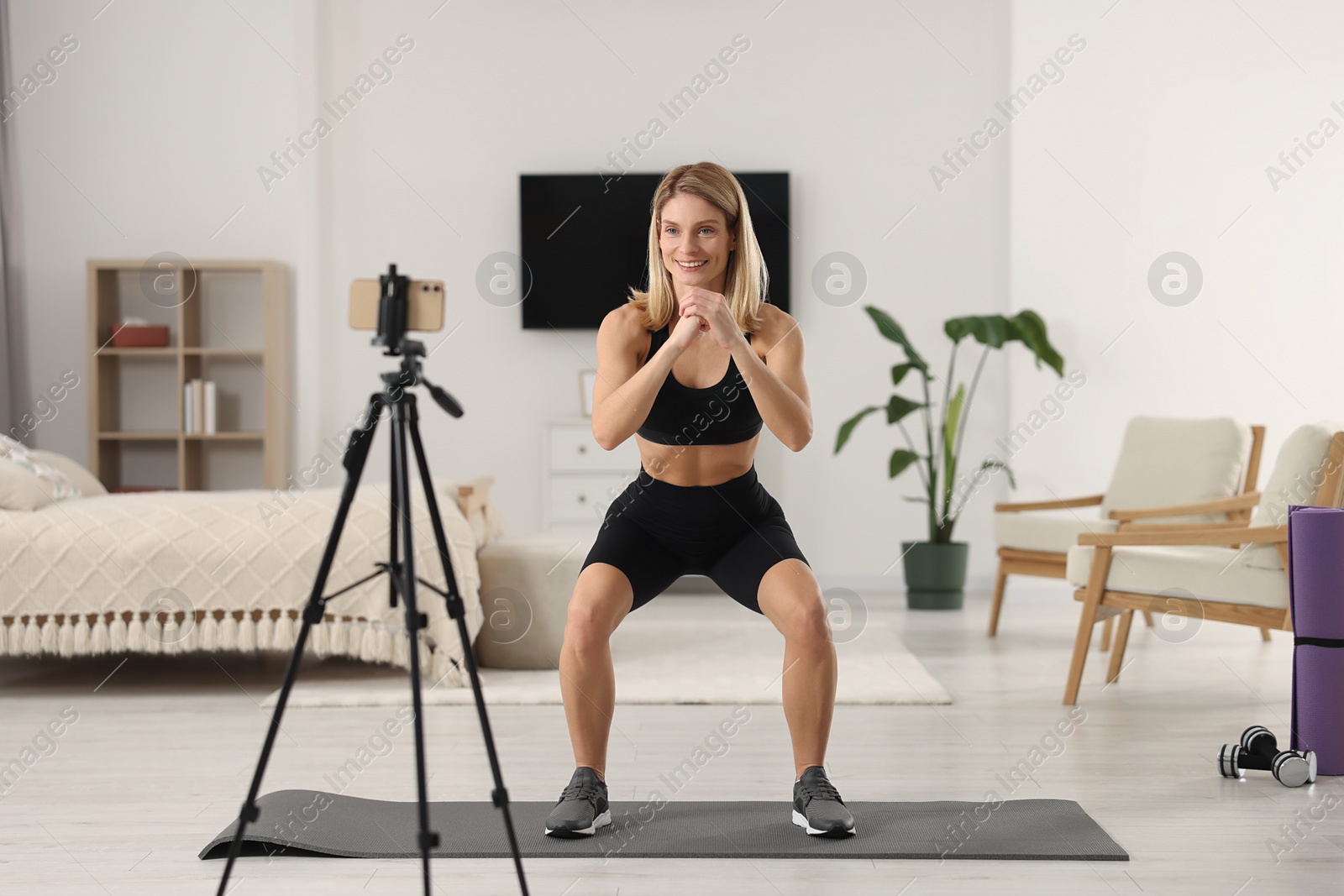 Photo of Fitness trainer recording online classes at home