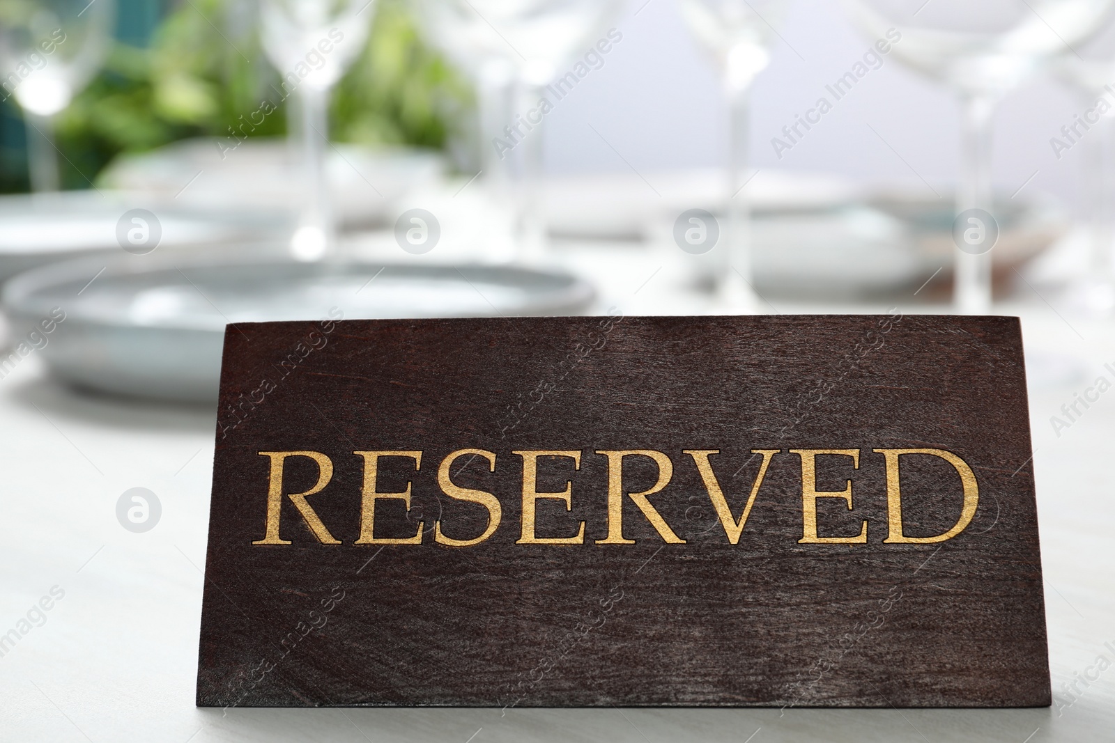 Photo of Table setting with RESERVED sign in restaurant