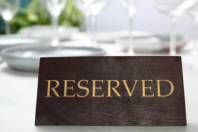 Table setting with RESERVED sign in restaurant