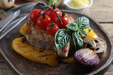 Photo of Delicious grilled meat and vegetables served on wooden table, closeup