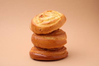 Stack of delicious rolls with raisins on beige background. Sweet buns