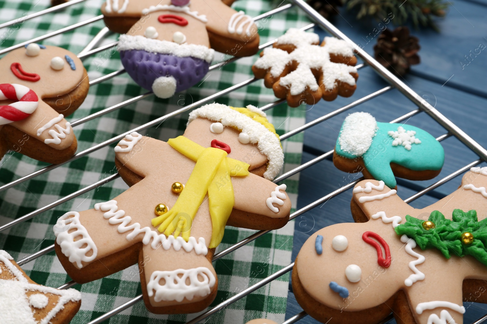 Photo of Delicious Christmas cookies on blue table, closeup