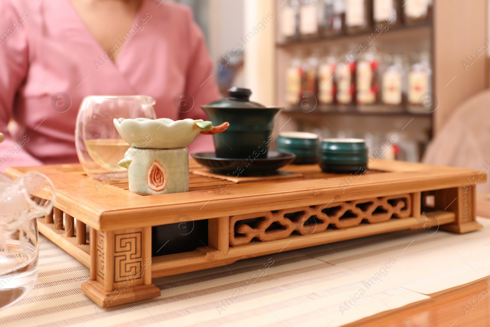 Photo of Traditional tea ceremony. Master near tools and tray, closeup