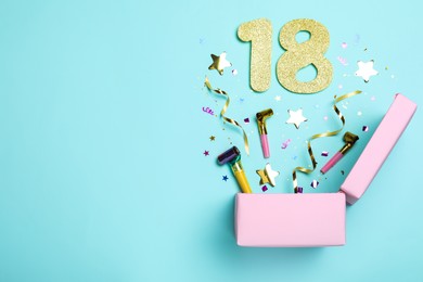 Photo of Flat lay composition with decor and numbers on light blue background, space for text. 18th birthday party