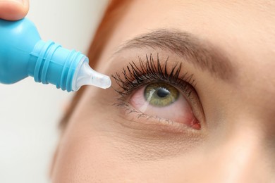 Image of Woman with conjunctivitis using eye drops, closeup