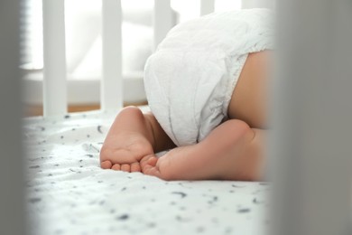 Photo of Cute little baby sleeping in crib, closeup
