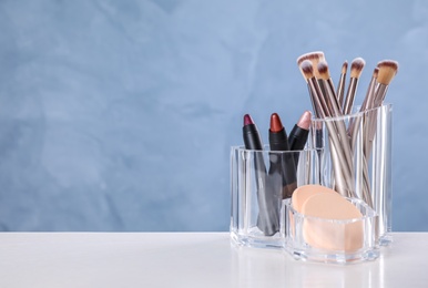 Photo of Make up brushes on white table. Space for text