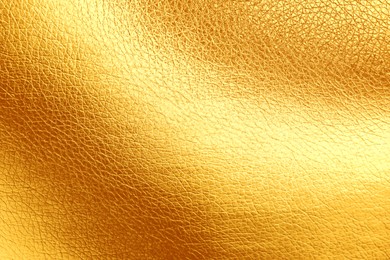 Texture of golden leather as background, top view