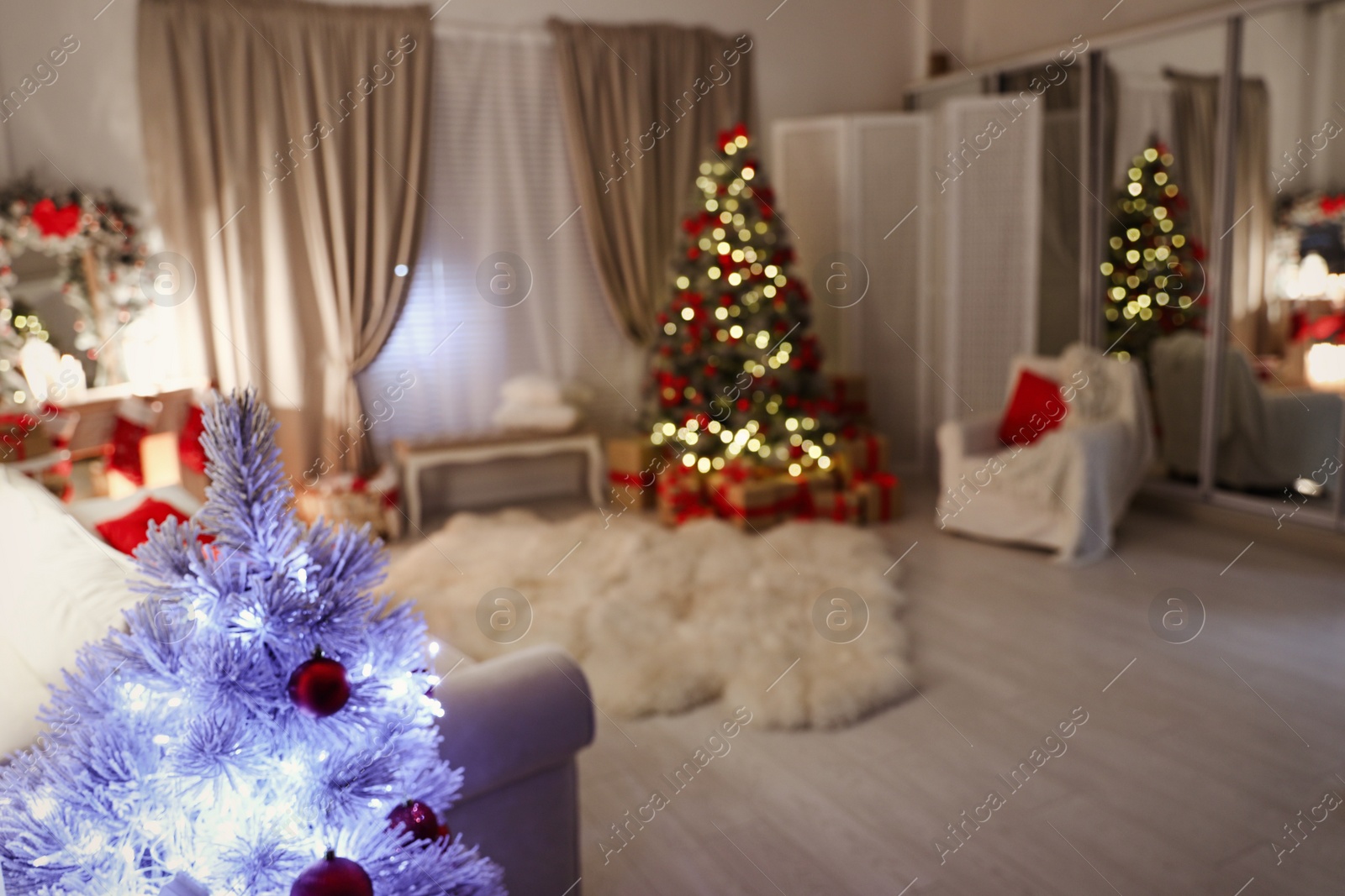 Photo of Blurred view of living room, focus on small Christmas tree