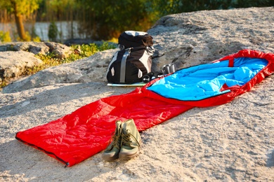 Sleeping bag and other camping gear outdoors on sunny day