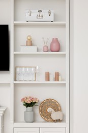 Shelves with different decor indoors. Interior design