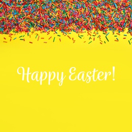 Image of Text Happy Easter and bright colorful sprinkles on yellow background, flat lay. Confectionery decor