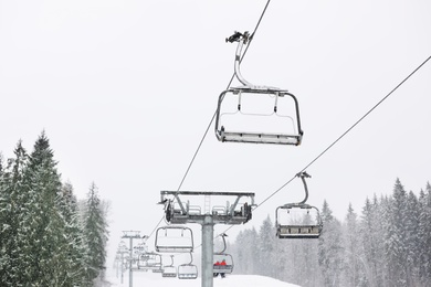 Photo of Ski lift at mountain resort. Winter vacation