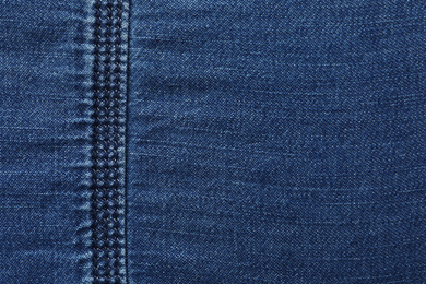 Photo of Texture of dark blue jeans as background, closeup