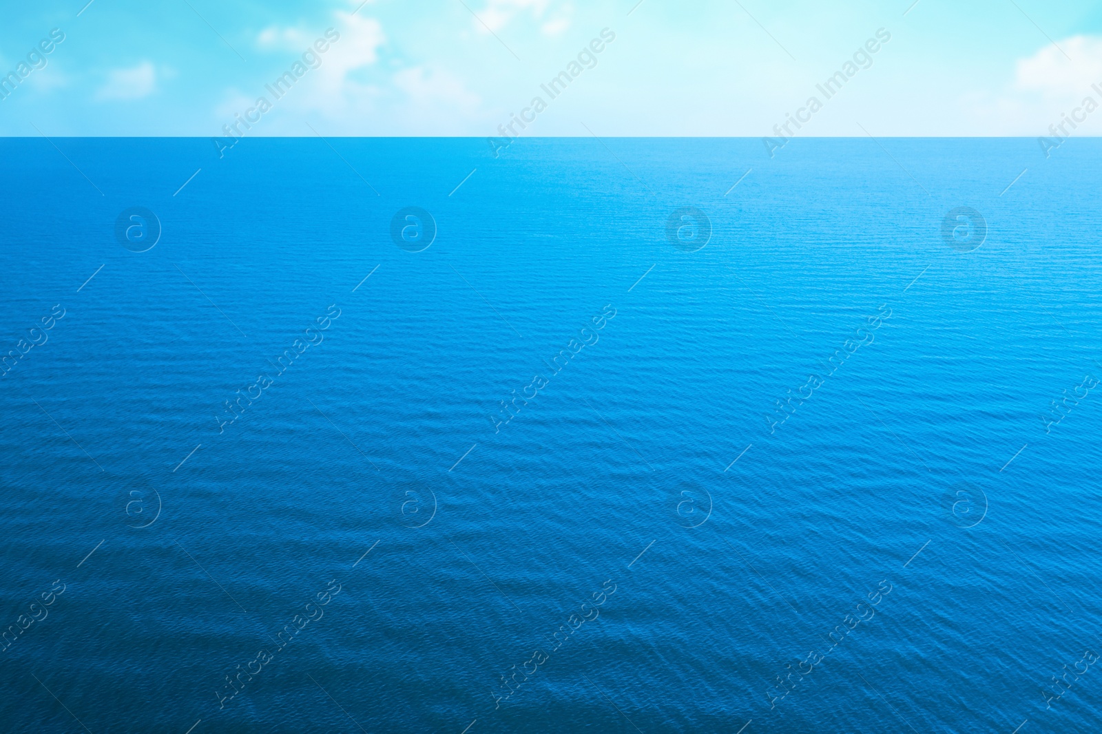 Image of Beautiful ripply sea under blue sky with clouds