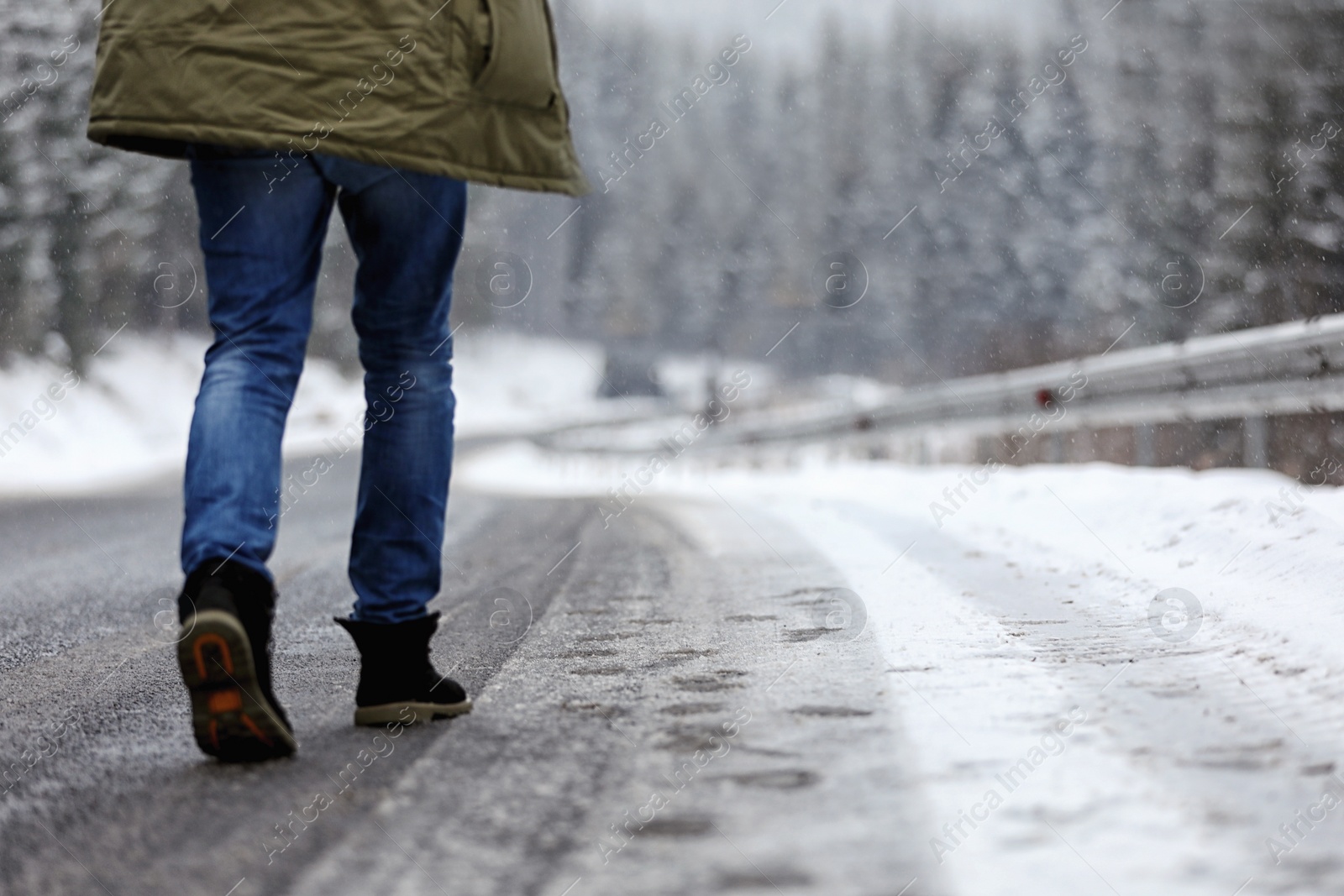 Photo of Man walking outdoors on snowy winter day. Space for text