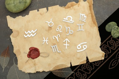 Photo of Flat lay composition with zodiac signs on grey textured table