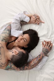 Photo of Passionate couple having sex on bed, top view