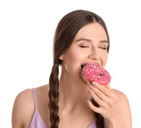 Beautiful young woman eating donut on white background