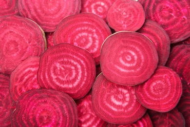 Sliced red beets as background, top view