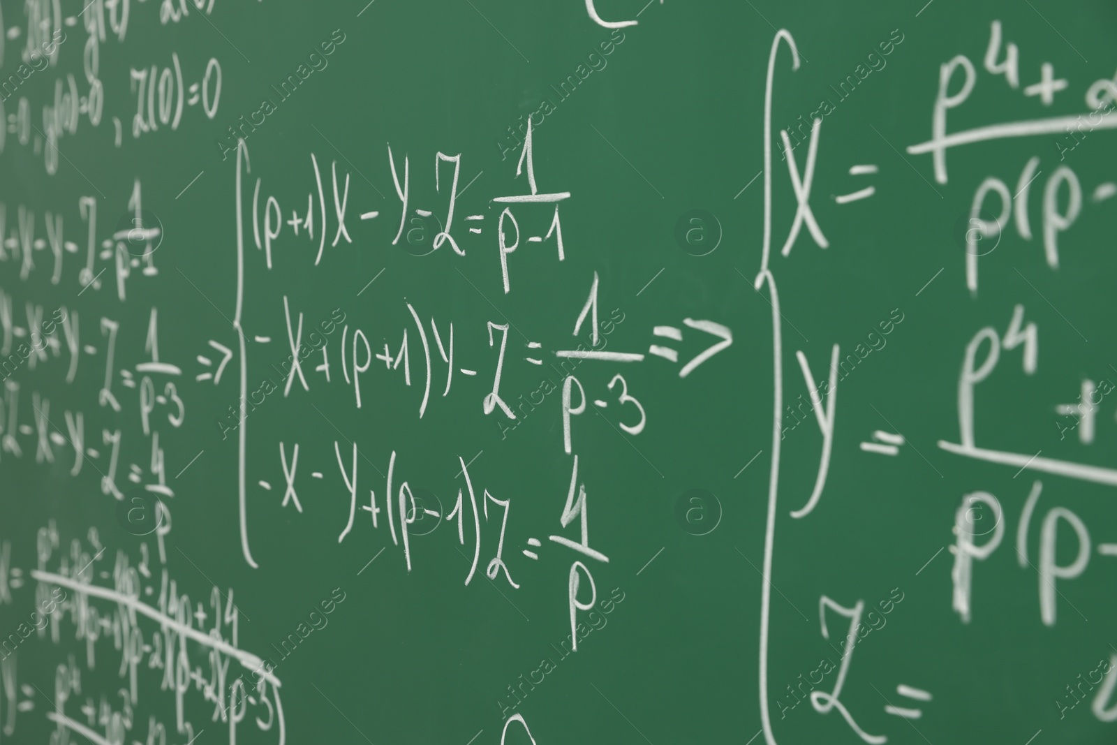 Photo of Many different math formulas written on chalkboard, closeup