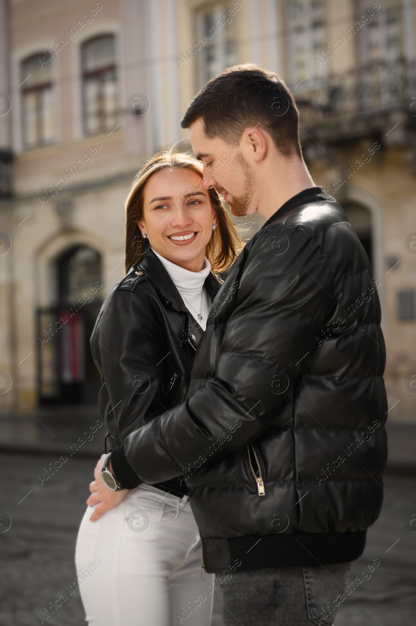 Photo of Lovely young couple together on city street. Romantic date