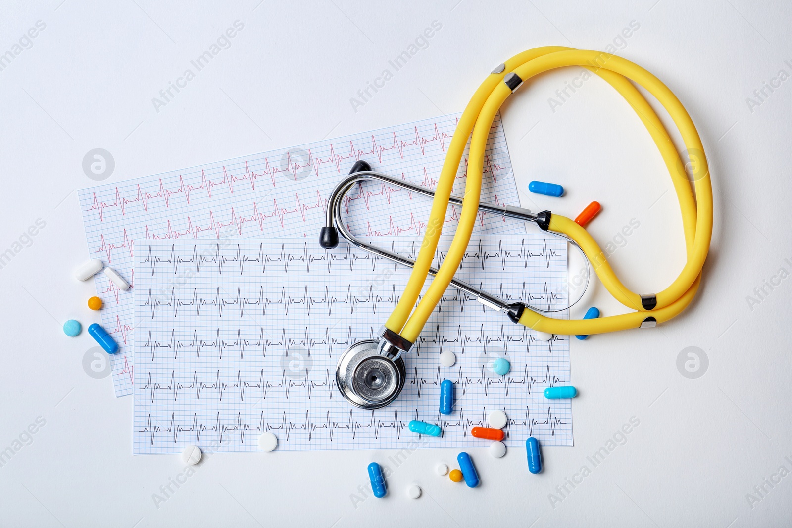 Photo of Composition with stethoscope and pills on white background. Cardiology service