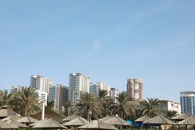 Photo of AJMAN, UNITED ARAB EMIRATES - NOVEMBER 04, 2018: Landscape with modern multi-storey buildings on sunny day