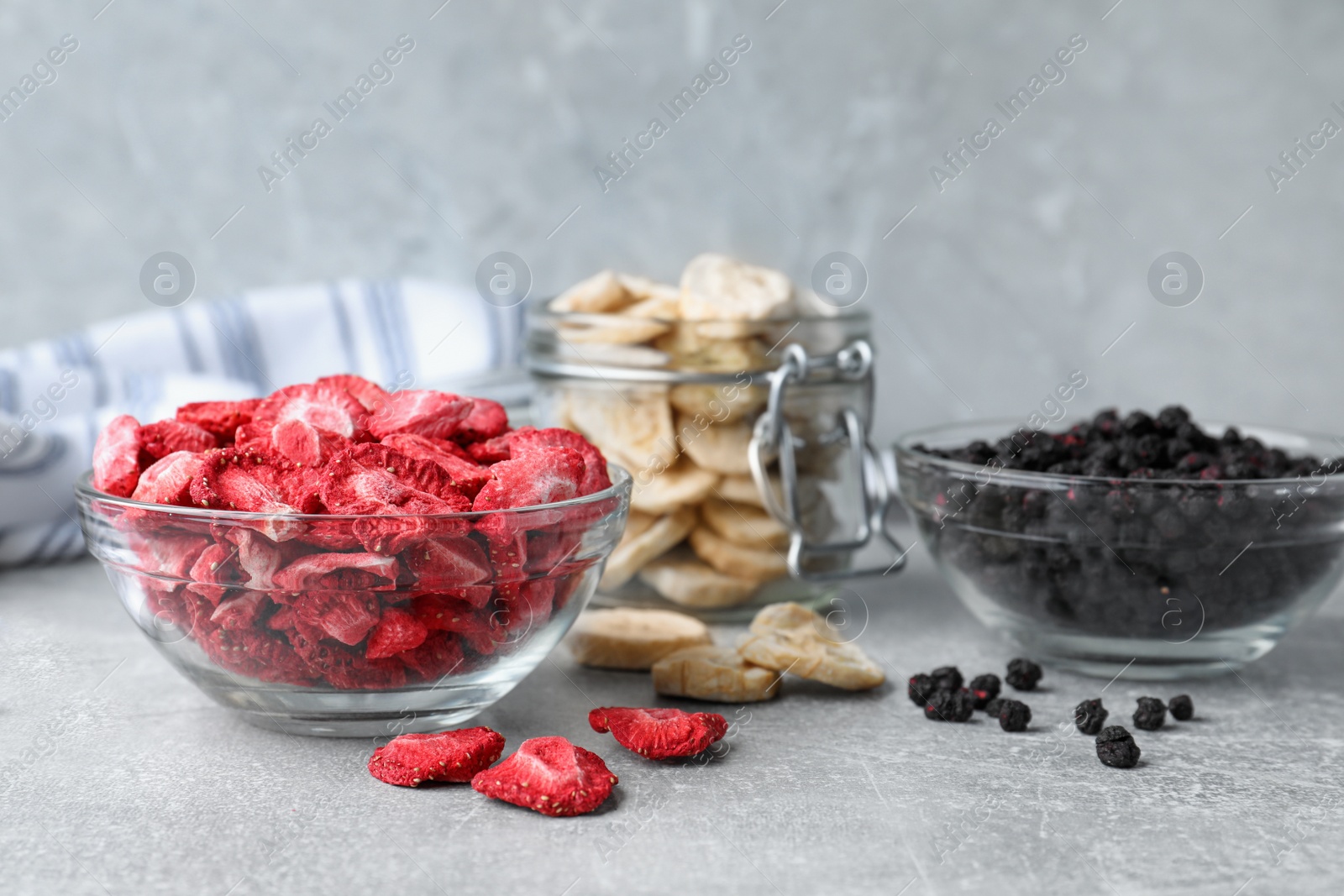 Photo of Many different freeze dried fruits on light grey table