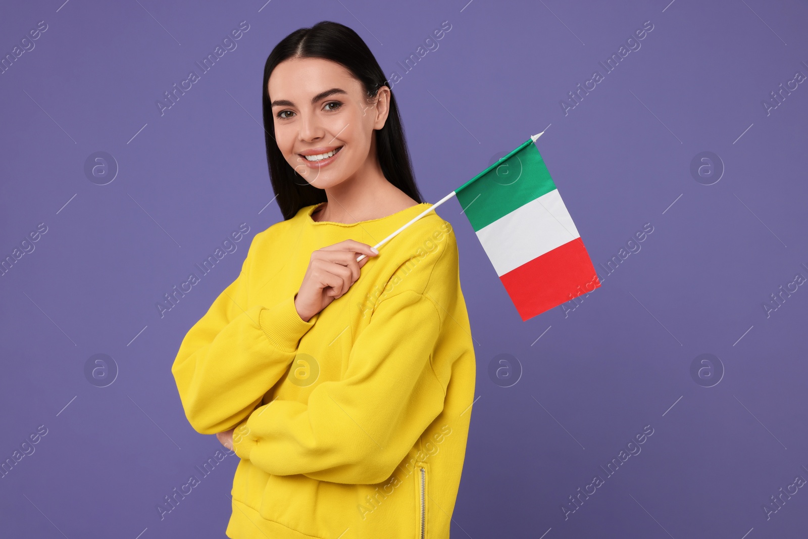 Photo of Happy young woman with flag of Italy on violet background