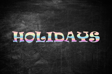 Word HOLIDAYS on black background. School's out