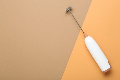 White milk frother wand on color background, top view. Space for text