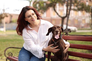 Woman with her cute German Shorthaired Pointer dog outdoors