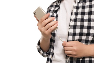 Man plugging headphones to smartphone on white background, closeup