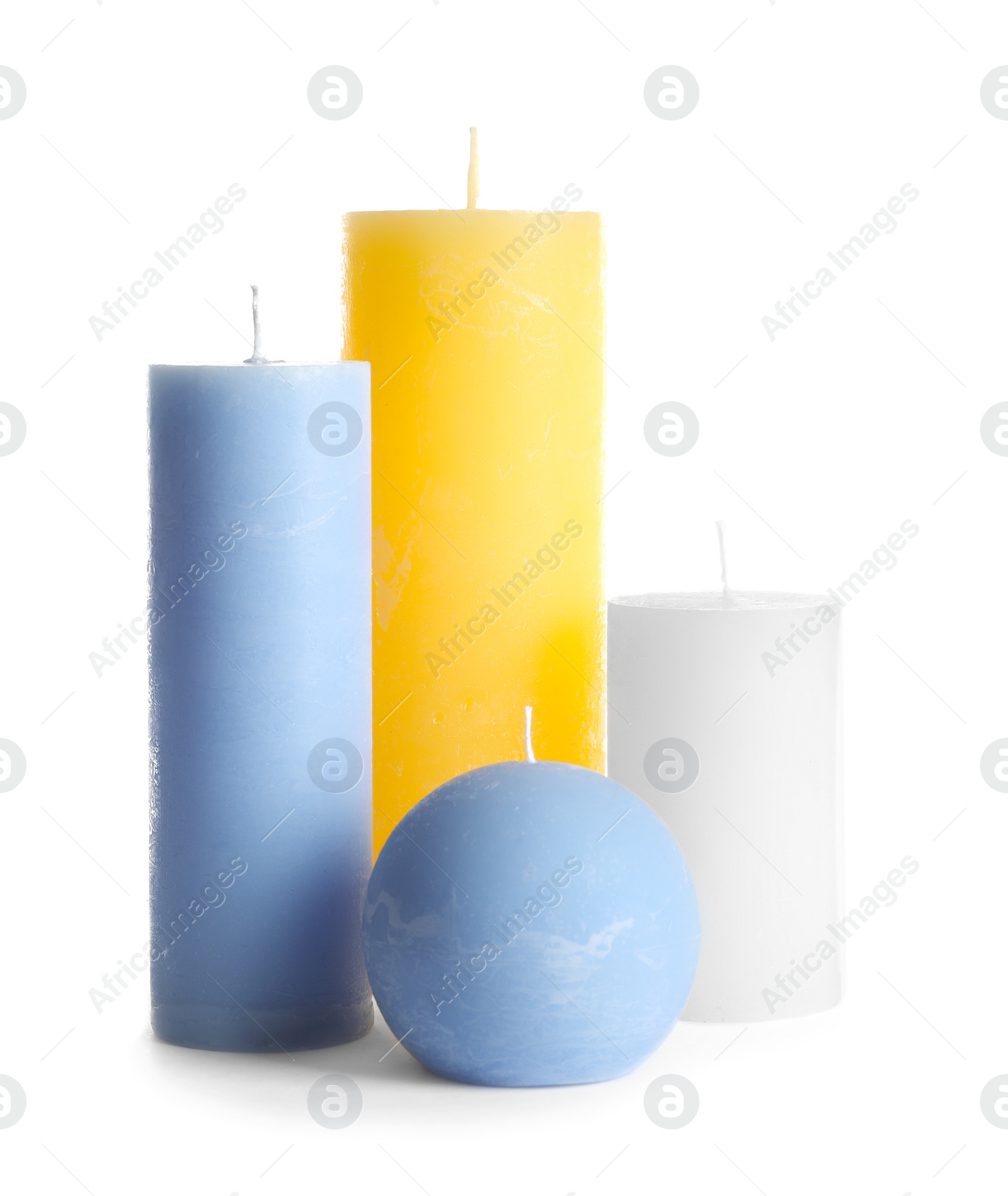 Photo of New wax candles of different shapes on white background