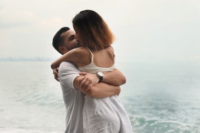 Photo of Happy young couple spending time together near sea