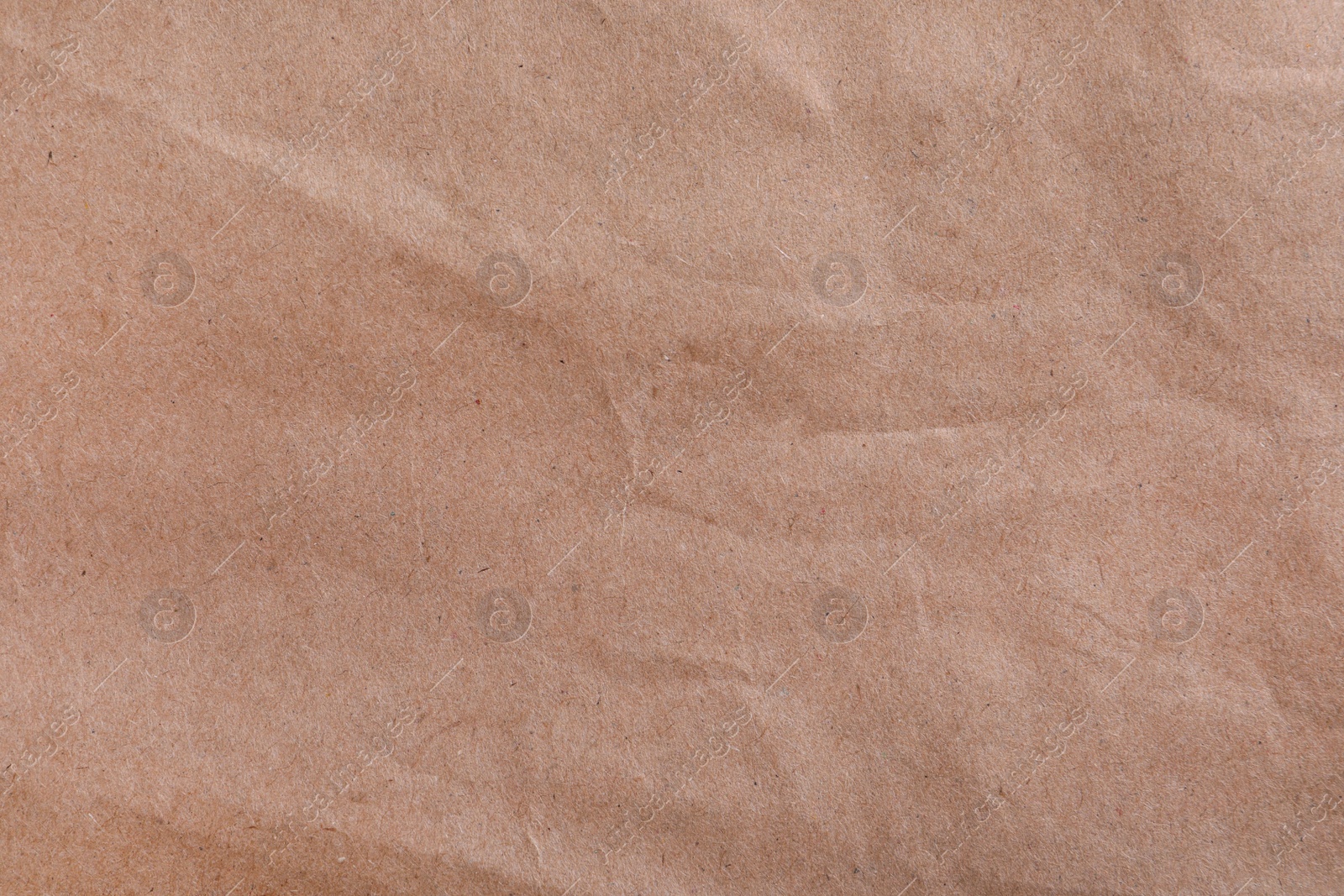 Photo of Texture of kraft paper bag as background, closeup