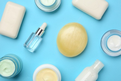 Photo of Flat lay composition with body care products on color background