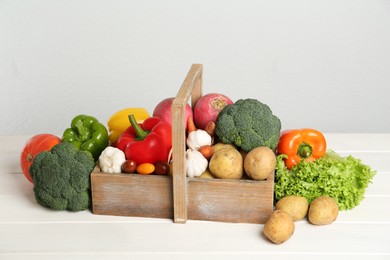 Assortment of fresh vegetables on white wooden table