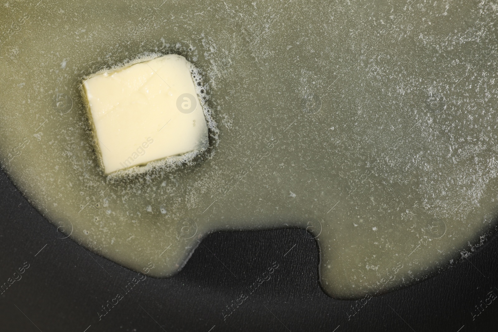 Photo of Melting butter in frying pan, top view