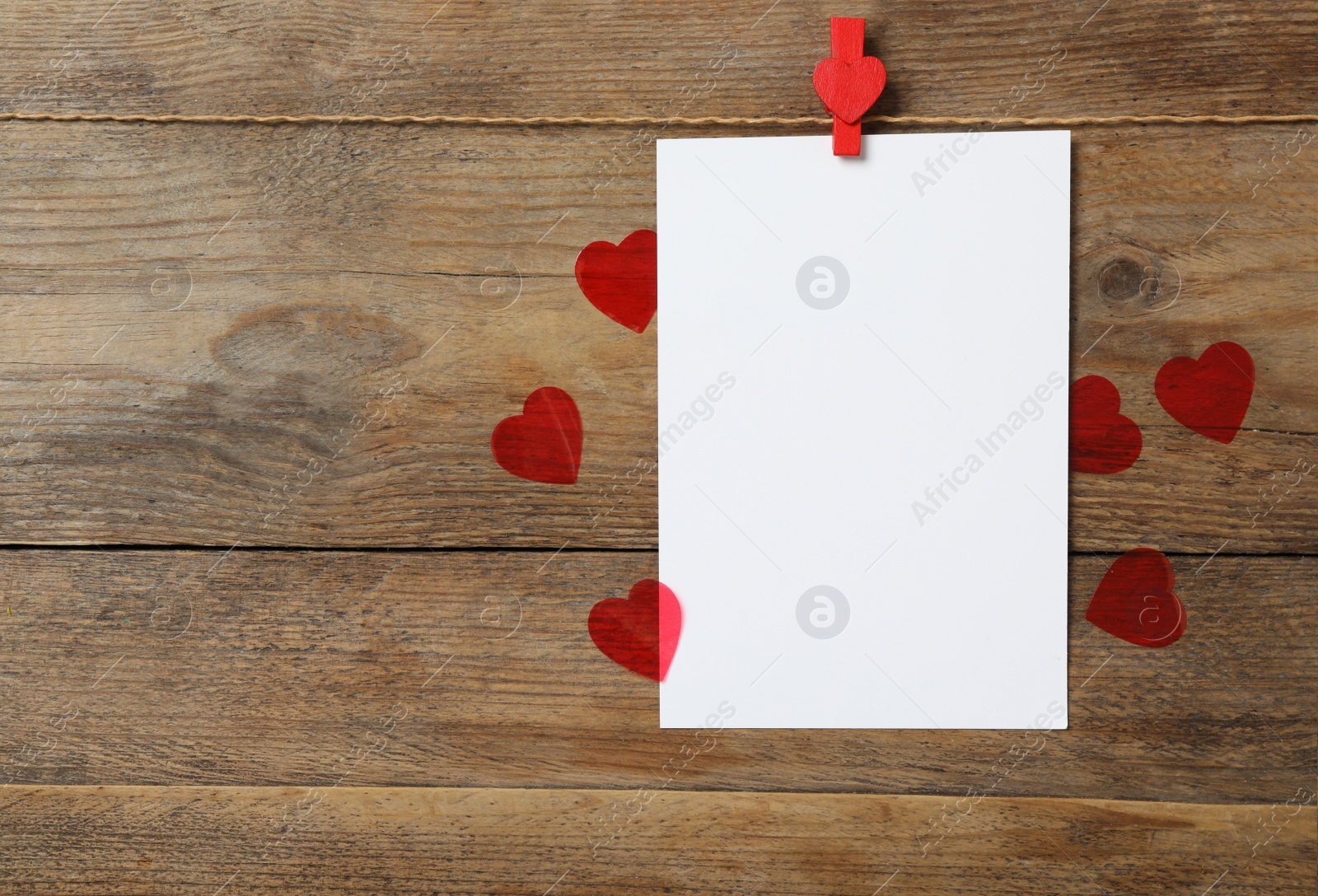 Photo of Blank card and hearts on wooden background, flat lay with space for text. Valentine's Day celebration