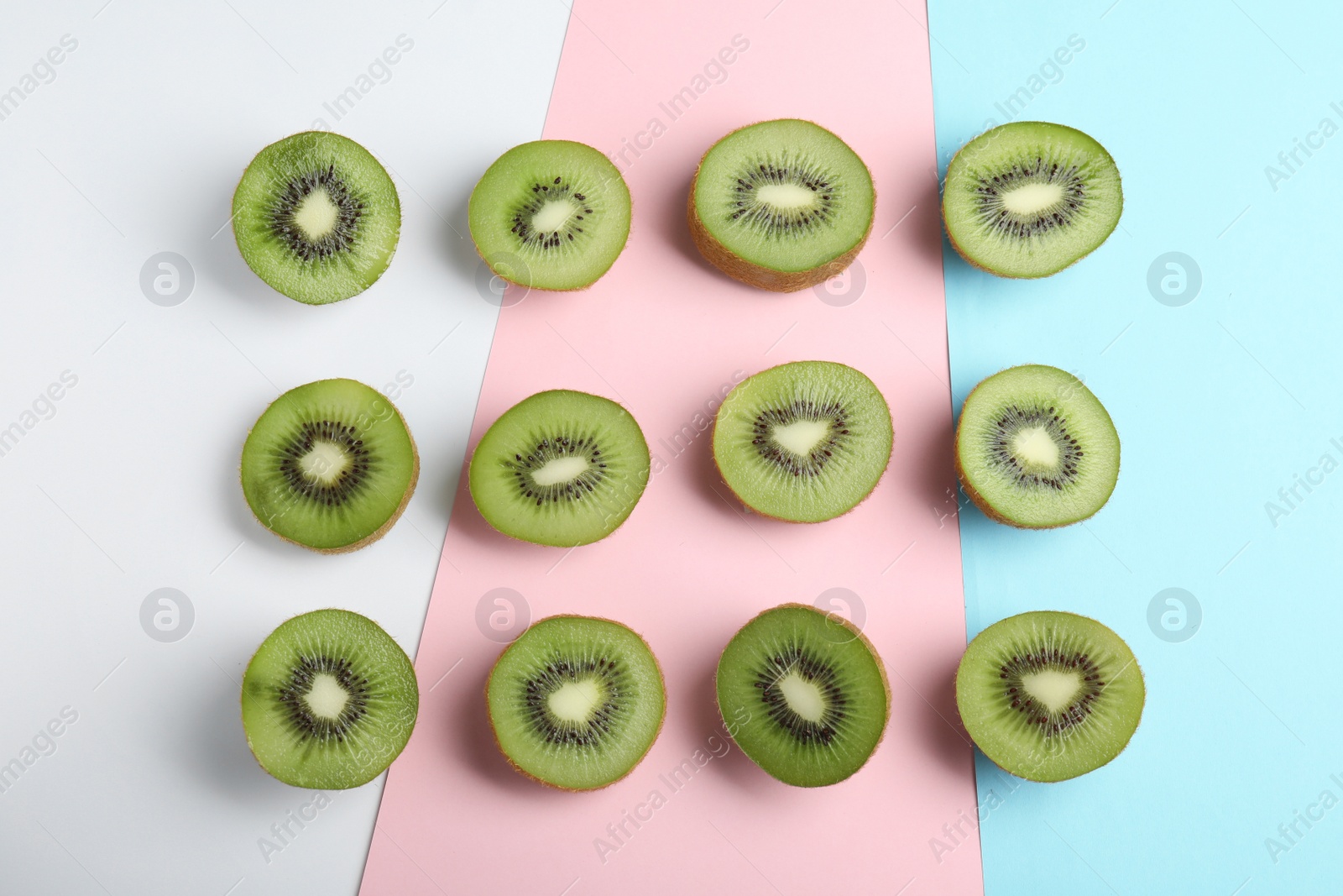 Photo of Top view of sliced fresh kiwis on color background